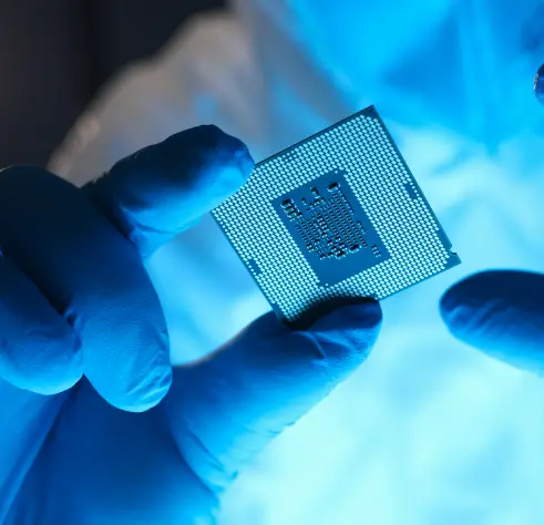 Semiconductor or electronic component chip being held up and examined