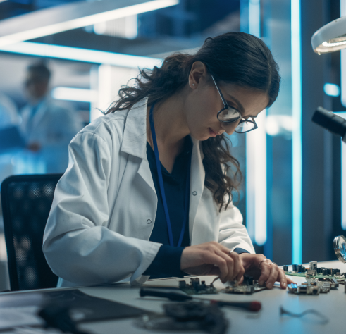 Female semiconductor lab worker or technician assembling electronic components